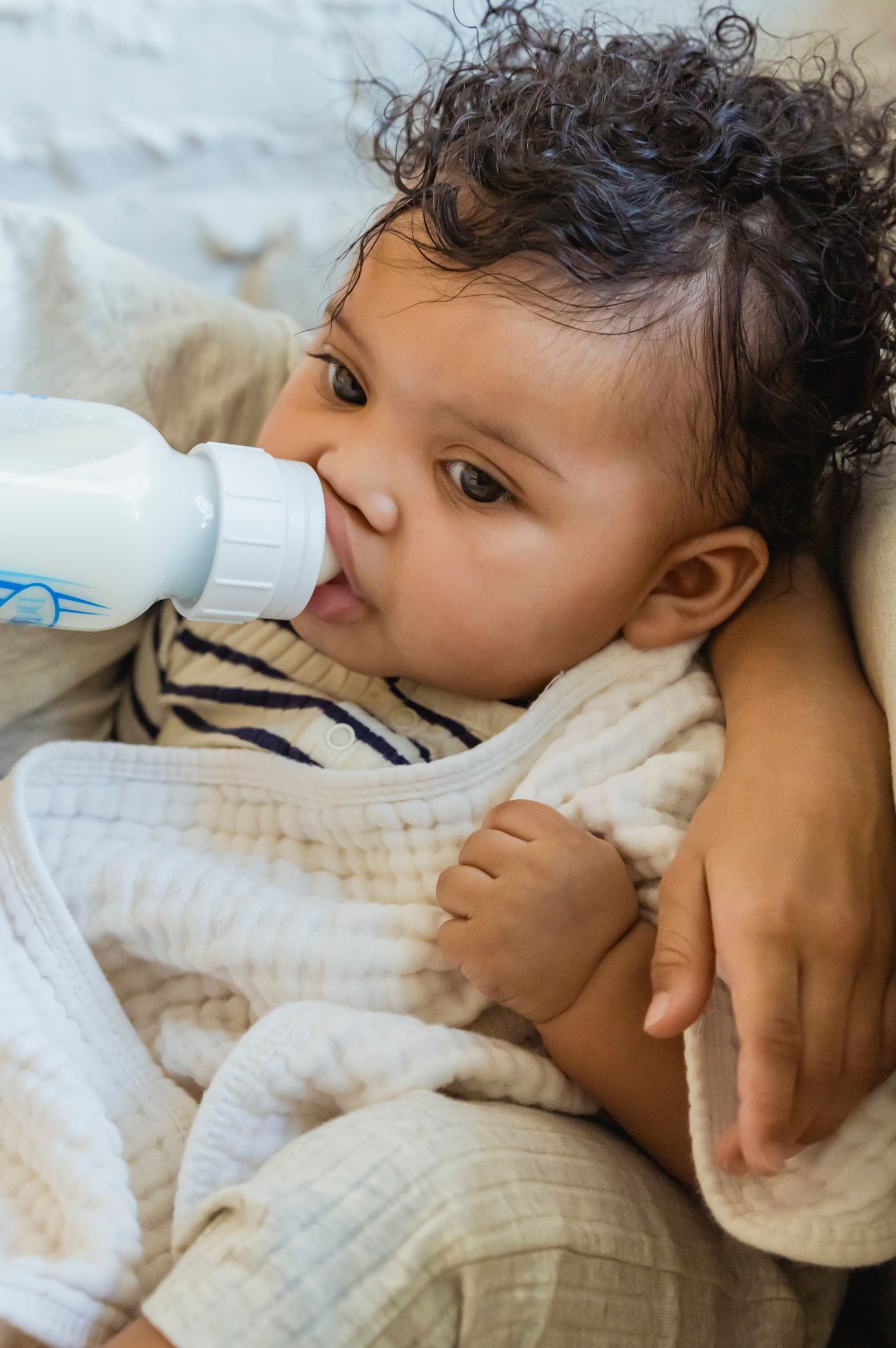 Baby drinking from plastic bottle