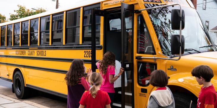 Kids getting on an electric school bus
